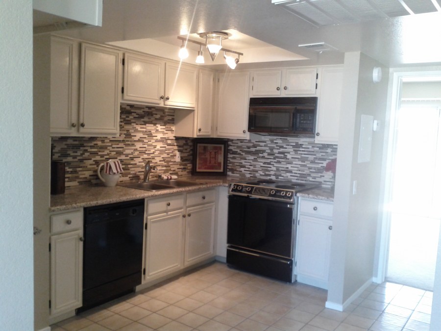 Kitchen as new granite counter top and tiles.