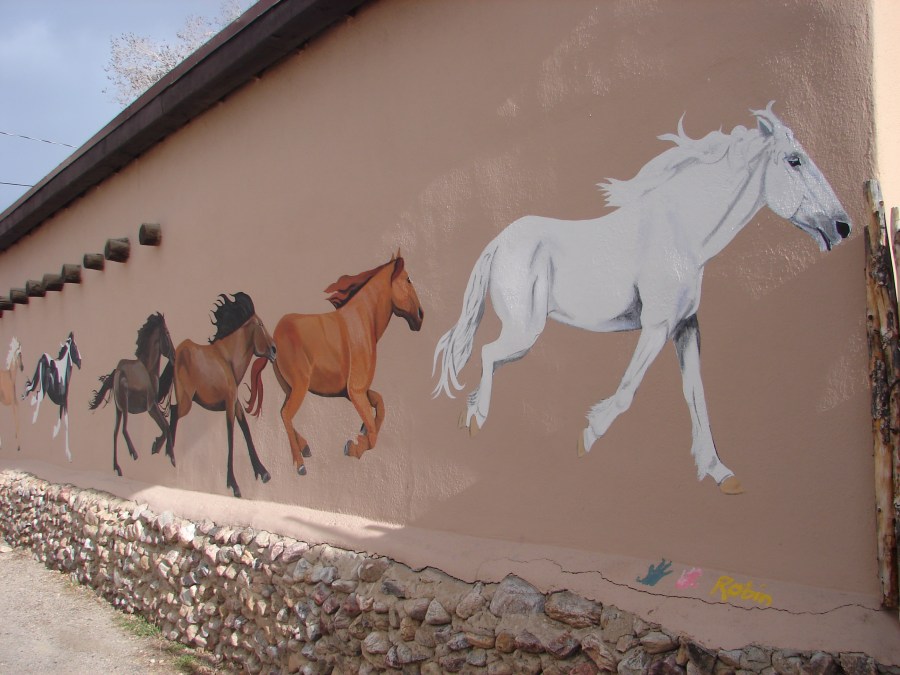 Other half of a horse mural on building.