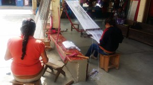 women weaving on back strap looms