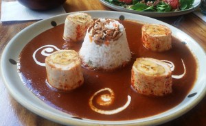 This is chicken wrapped in rice and red mole.