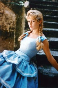 Brigitte Bardot inspired dozens of style moments, from her iconic cat eye makeup to bouffant hair and black headbands. Here, she proves that a sweet gingham dress can have a sultry side.