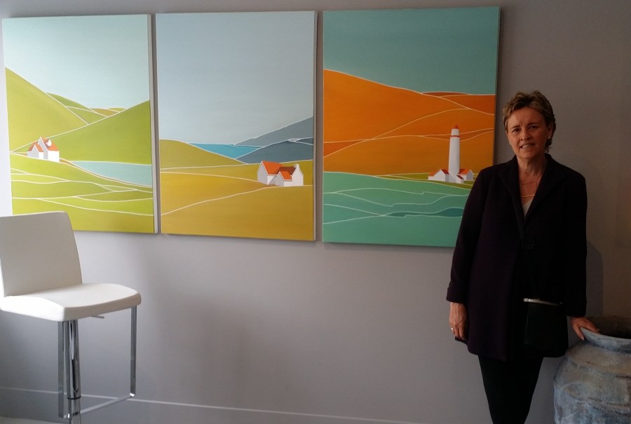 Georgina Masana stands next to her paintings