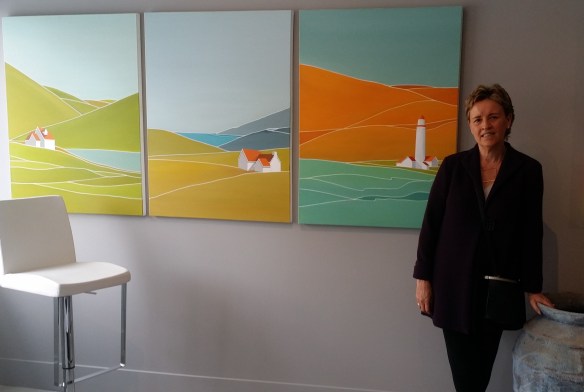 Georgina Masana stands next to her paintings