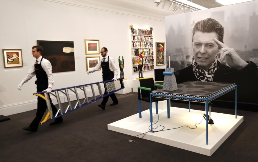Technicians prepare artworks from the Bowie Collection to go on display at Sotheby's. AP Photo/Kirsty Wigglesworth 