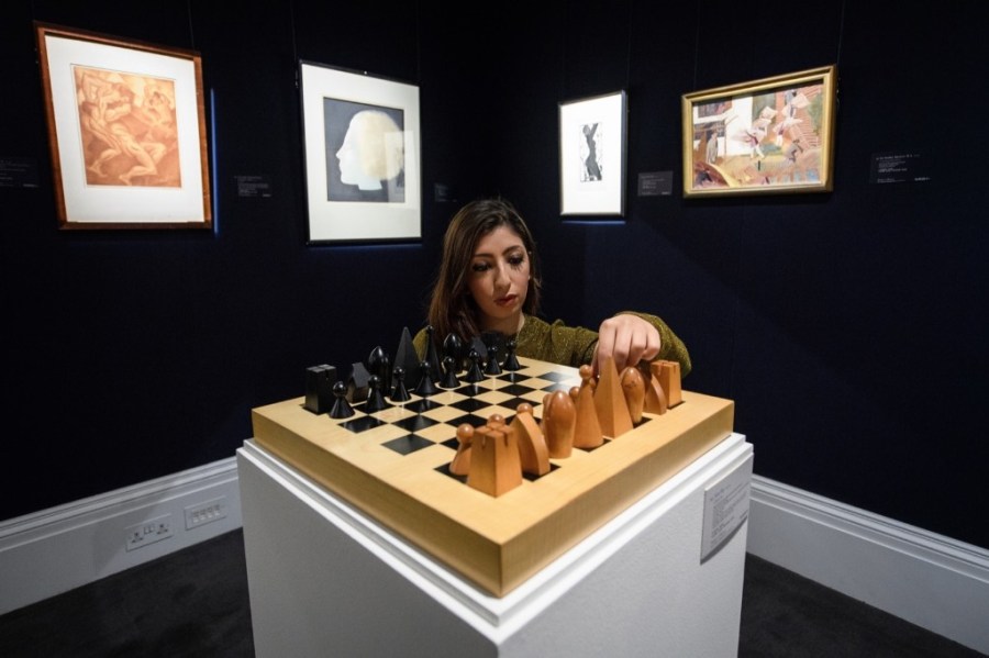 A gallery assistant poses with 