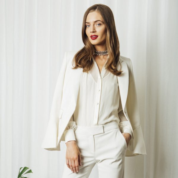 Major Monochrome A crystal necklace puts a glamorous finishing touch on an all-white uniform for the office.