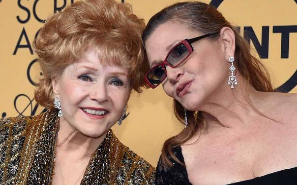 Debbie Reynolds, recipient of the Screen Actors Guild Life Achievement Award, and her daughter, actress Carrie Fisher, pose in the press room during the 21st Annual Screen Actors Guild Awards on January 25, 2015.(Ethan Miller/Getty Images)